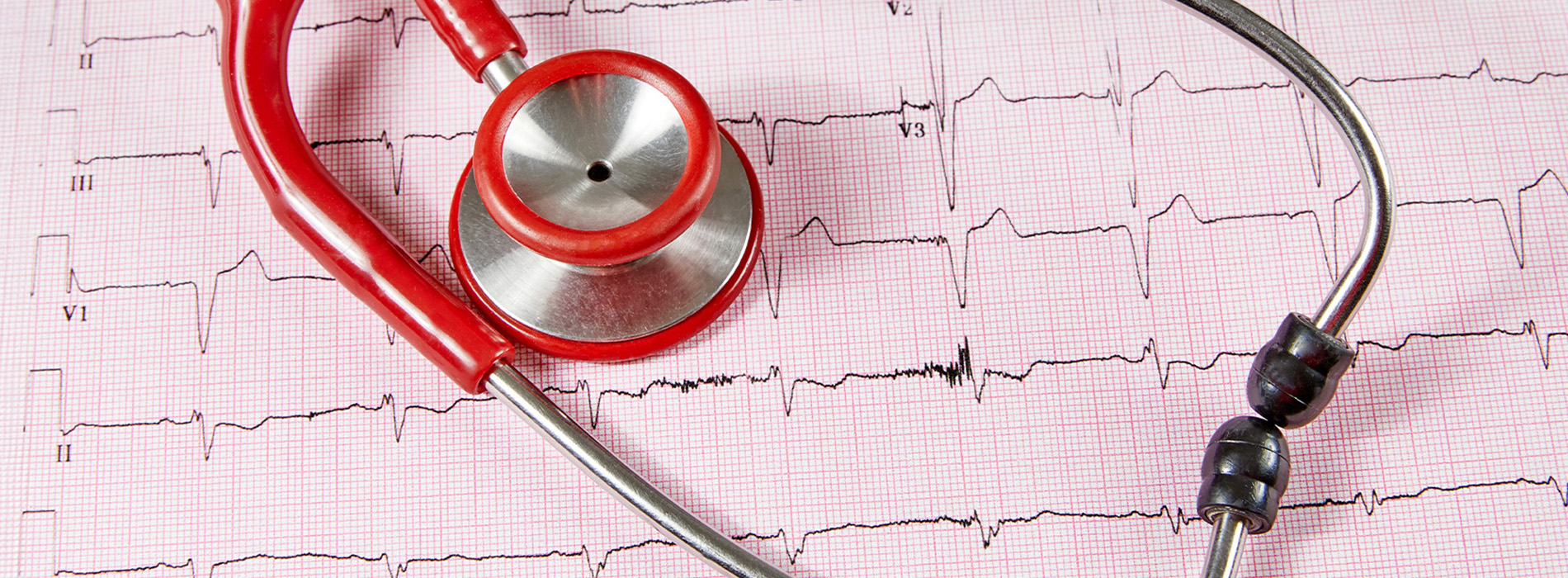 The image shows a stethoscope with an earpiece placed on top of a heartbeat pattern, which is likely a representation of an ECG or pulse monitor, against a red and white checkered background.