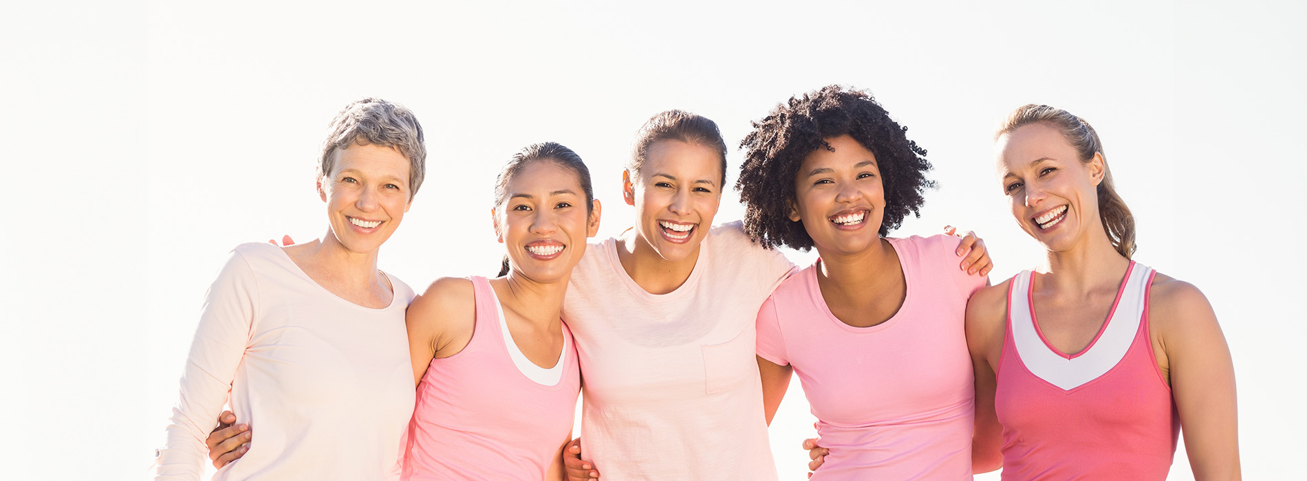 A group of six individuals posing together with smiles, wearing athletic clothing, set against a plain background.